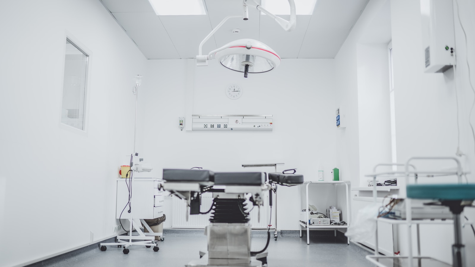 Photo by Arseny Togulev black and white hospital bed in the middle of interior building